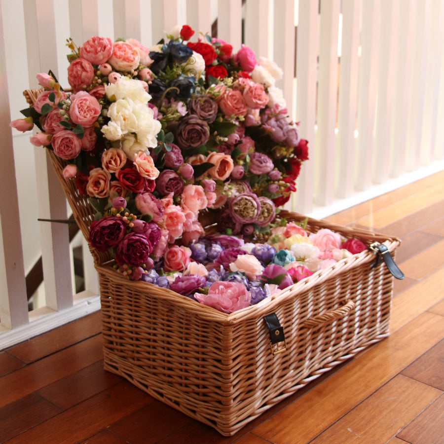 A basket full of red, pink, white and violet flowers