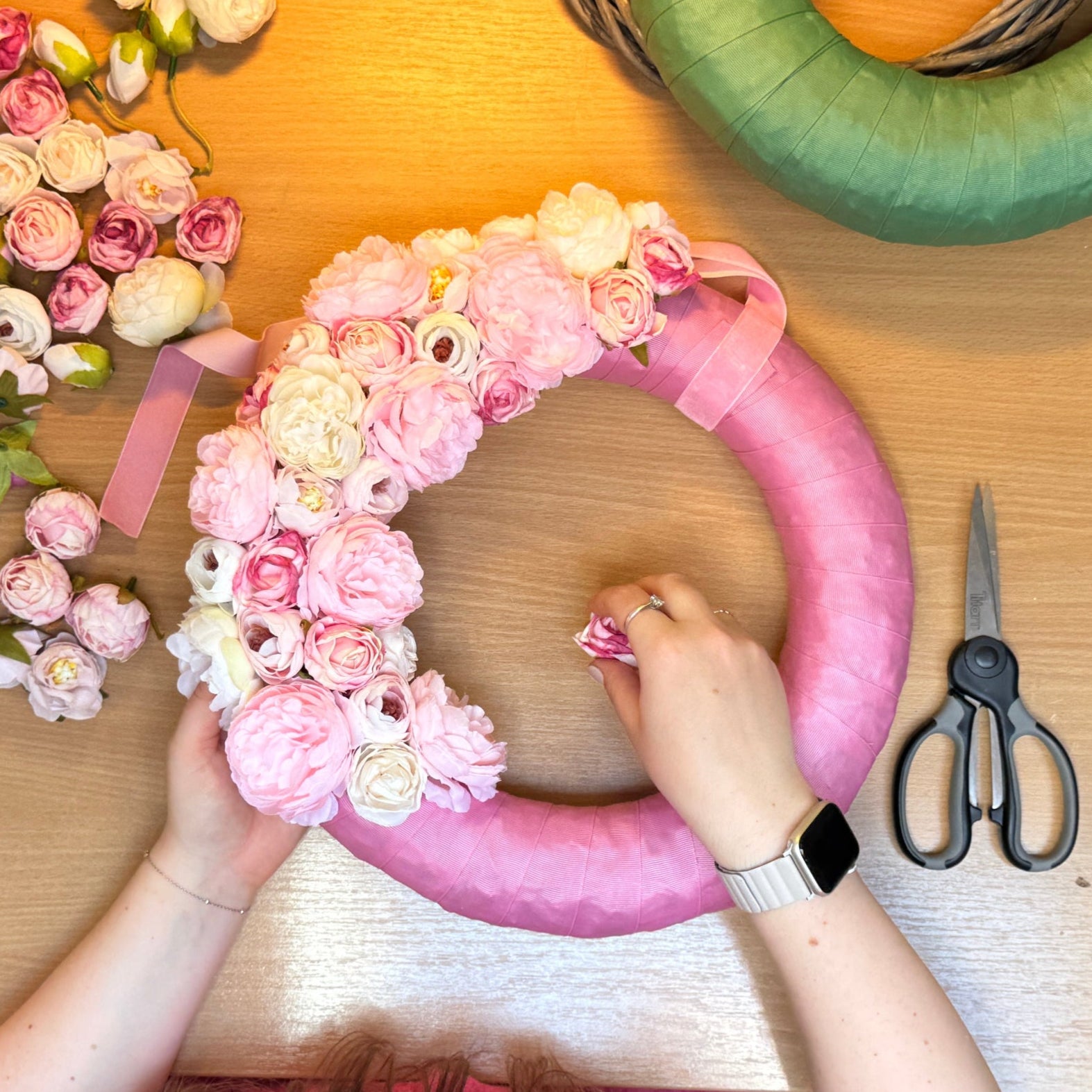 Making of a pink decorative wreath from artificial flowers