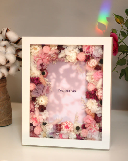 A white floral decorative photo frame with pink and white flowers
